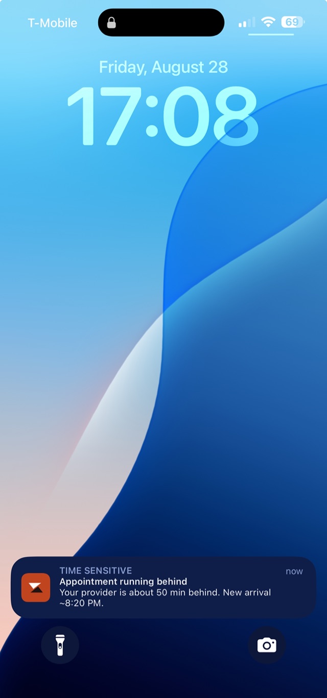 iPhone lock screen with a Zafvio notification: appointment running behind, new arrival about 8:20 PM